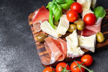 meat platter or cheese platter jamon, cheese, olives healthy meal food snack on the table copy space food background rustic top view