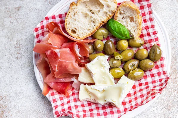 meat platter or cheese platter jamon, cheese, olives healthy meal food snack on the table copy space food background rustic top view