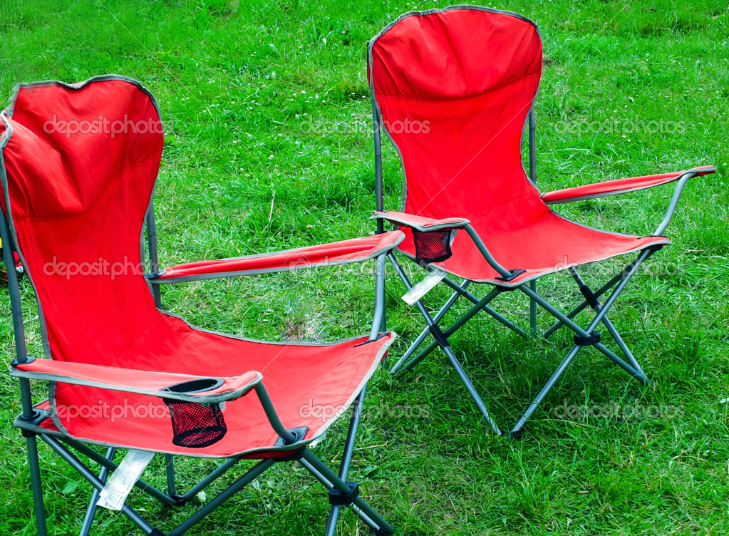 Folding chairs for outdoor recreation spring grass Stock Photo by