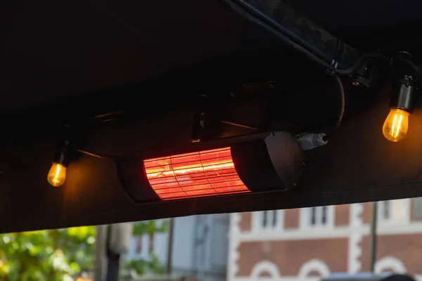 close-up of a powered patio heater outdoors of a restaurant, concept for negative carbon footprint