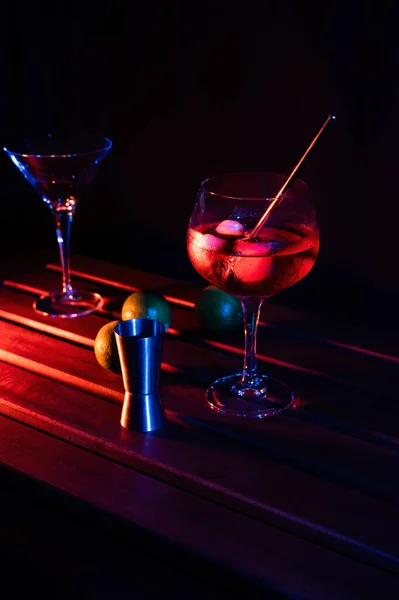 Cocktail glasses and cocktail utensils with colored lights