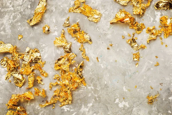 Luxurious golden background. Gold patal, precious flakes. The colors of the year are yellow gray, Stock Photo