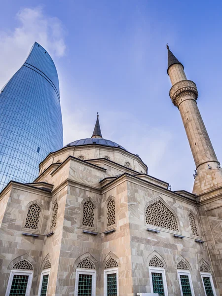BAKU, AZERBAIJAN - NOVEMBER 22, 2013: Sehidler Mescidi Mosque next to the Flame Towers in Baku, Azerbaijan. Flame Towers are the first flame-shaped skyscrapers in the world. — Stock Photo, Image