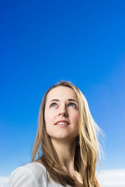 Girl looks up in the sky Royalty Free Stock Photos