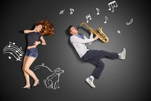 Playing the sax for her. — Stock Photo, Image