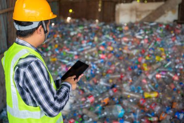 A workers work on recycle waste, Recycling Analyst looking at recycling waste To proceed to the next process. 