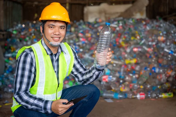 A recycling Analyst show at plastic bottle ofr recycling waste To proceed to the next process at recycling factory.