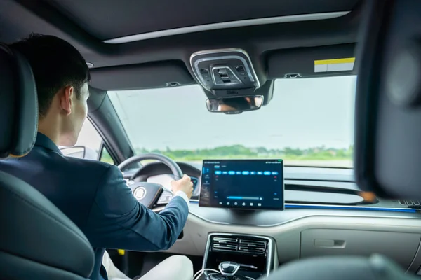 A man driving inside of electric car. Electric car. EV Car. EV vehicle.