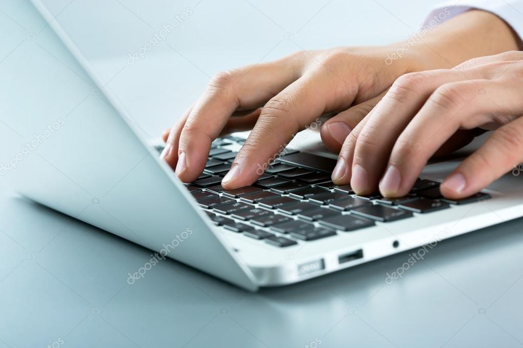 Businessman typing on laptop