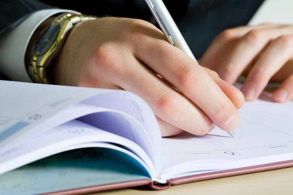 Businessman making notes — Stock Photo, Image