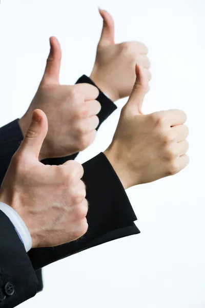 Бізнесмени показують великі пальці вгору — стокове фото