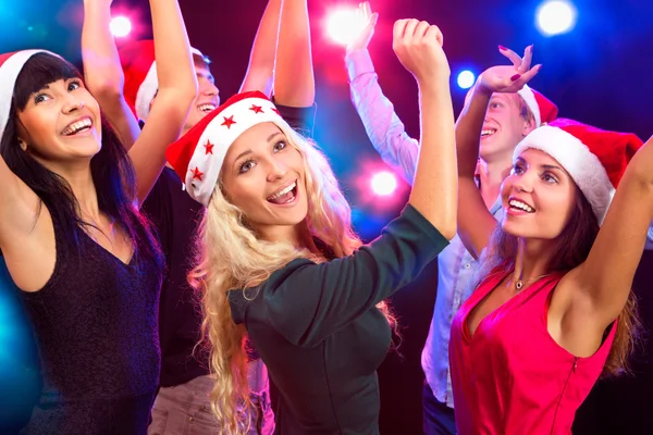 Happy people in Santa hats — Stock Photo, Image