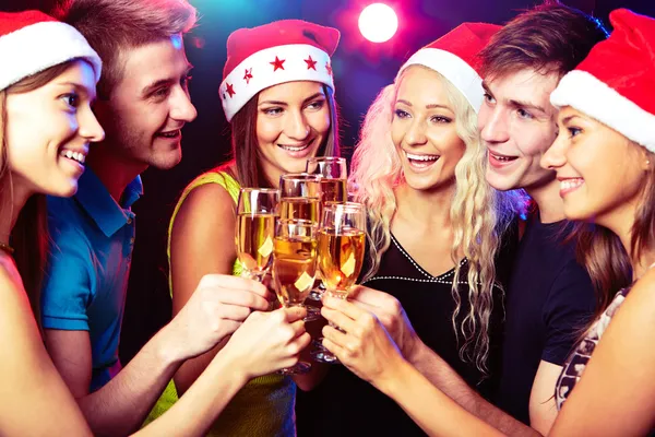 Young friends touching the glasses with each other — Stock Photo, Image