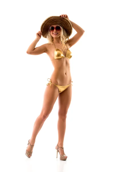 Slim meisje in gouden bikini — Stockfoto