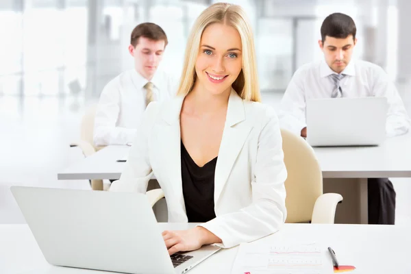 Cute businesswoman in an office — Stock Photo, Image