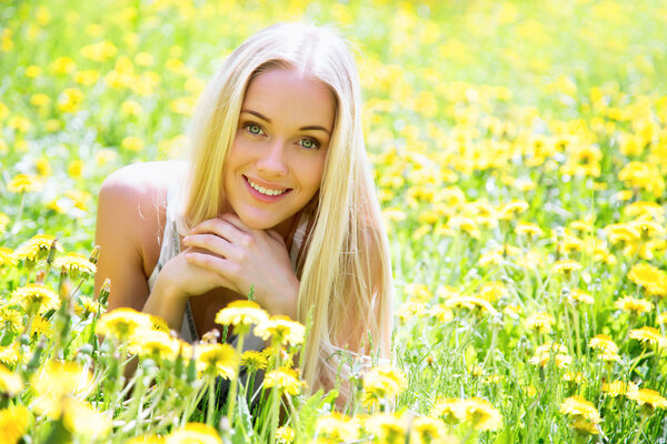 Beautiful young woman among the flowers