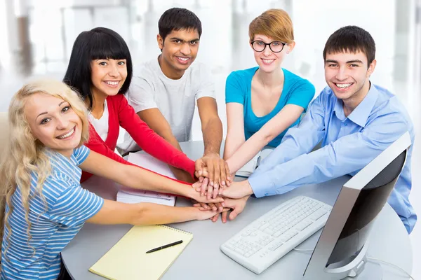 Students showing unity with their hands together — Stock Photo, Image