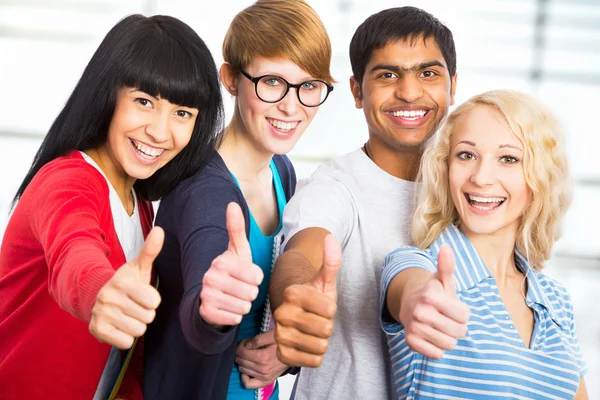 Students giving the thumbs-up sign — Stock Photo, Image