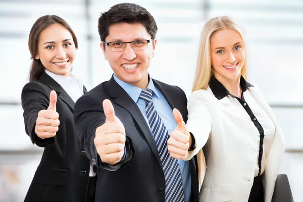 Business team showing thumbs up — Stock Photo, Image