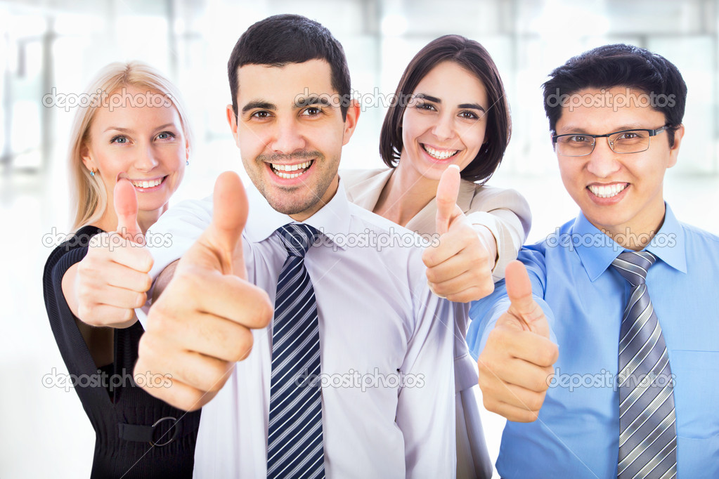 Business people showing thumbs up sign