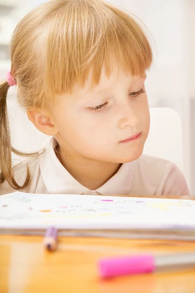 Mädchen schaut sich Werbebuch an — Stockfoto