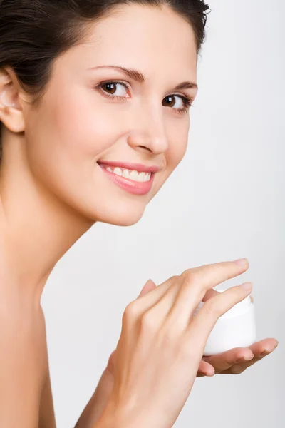 Woman applying cream — Stock Photo, Image