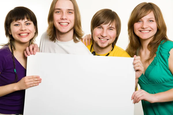 Four teenagers with poster — Stock Photo, Image