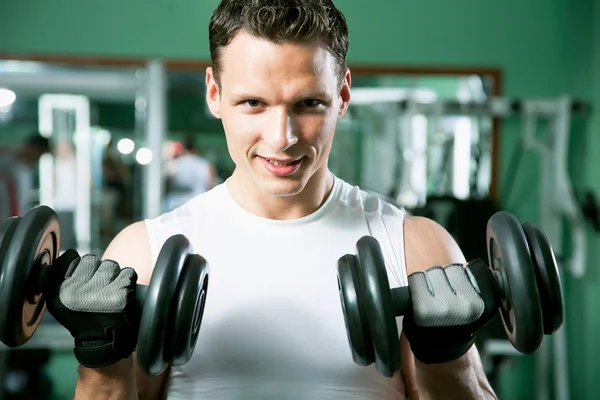 Man with weight training equipment — Stock Photo, Image