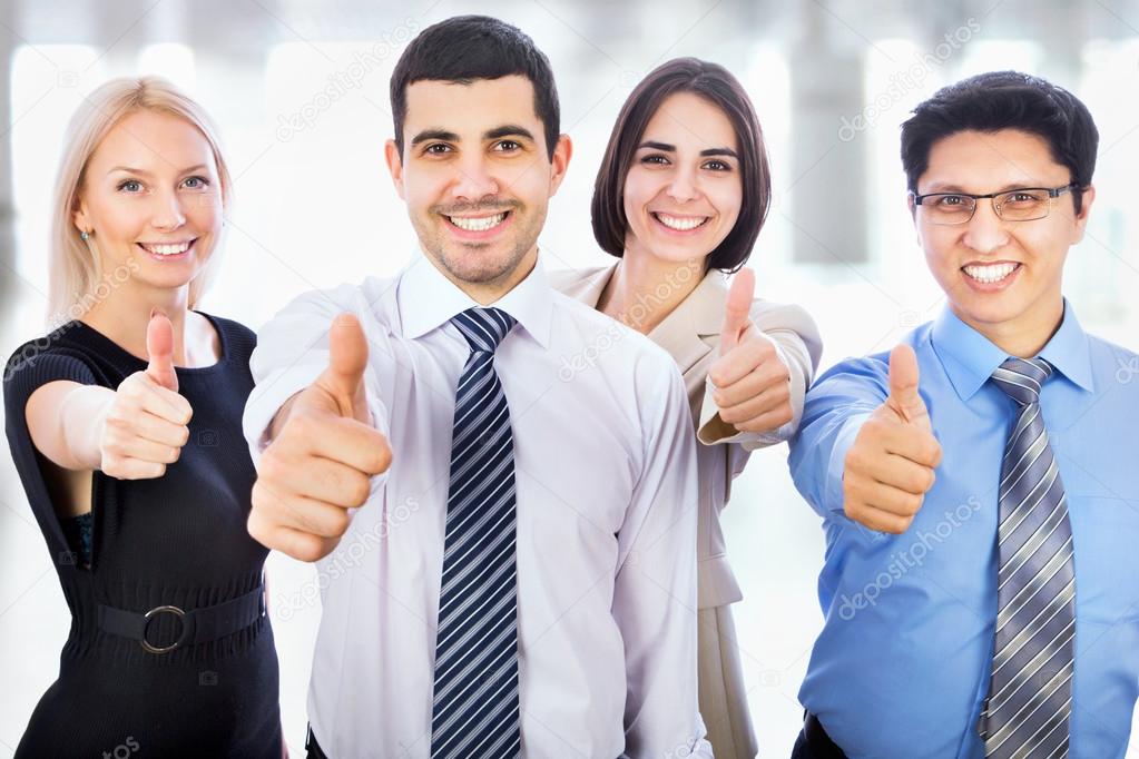 Business people showing thumbs up sign