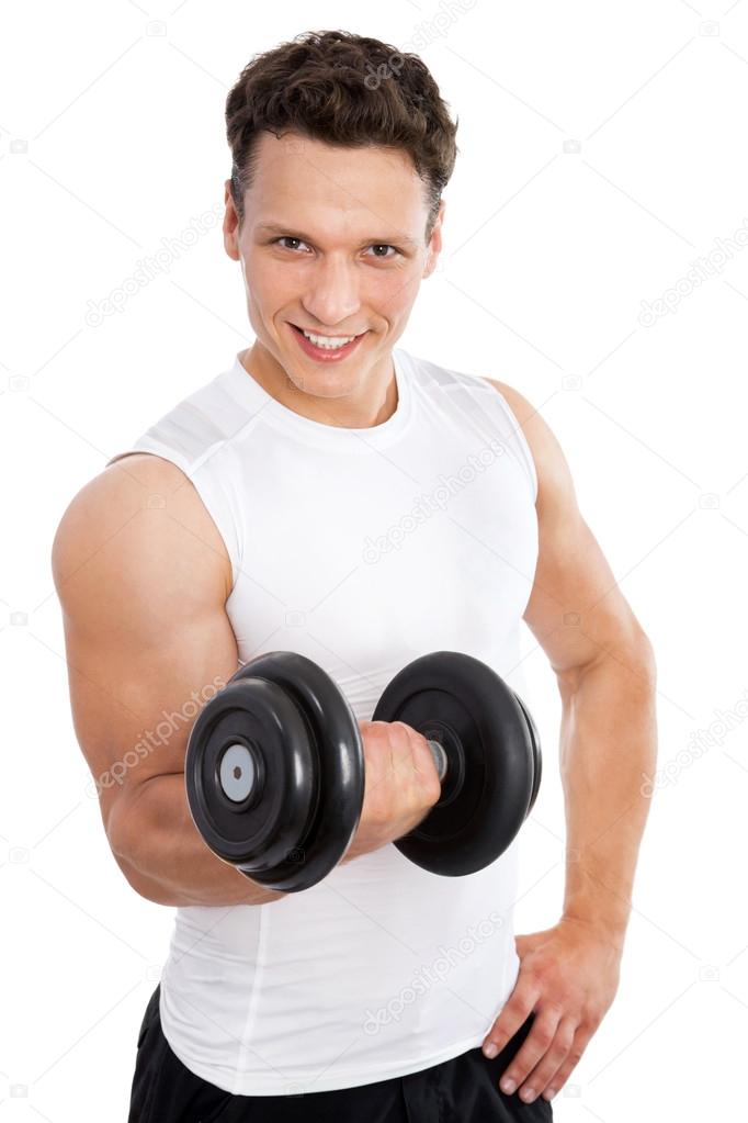 Satisfied young strength man lifting dumbbell