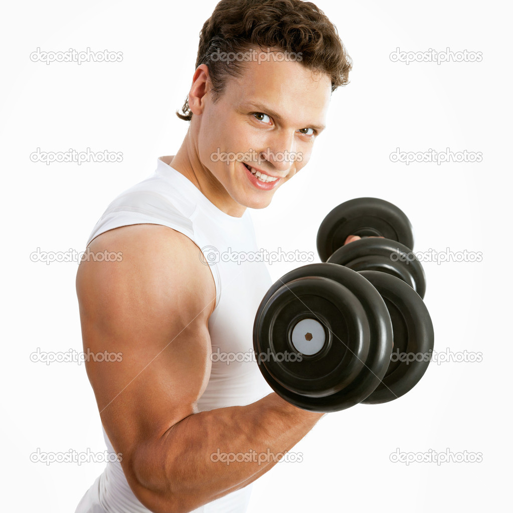 Satisfied young strength man lifting dumbbell