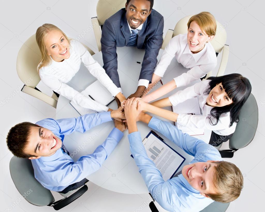 Business team making pile of hands