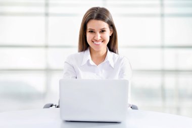 Business woman working on laptop clipart