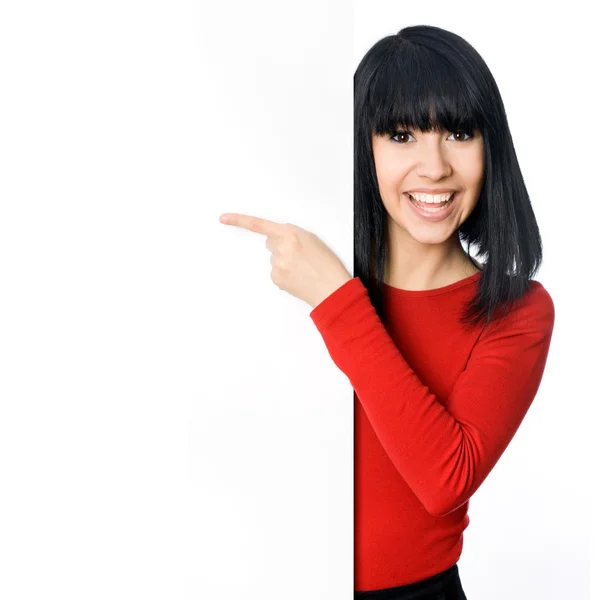 Girl pointing at a blank board — Stock Photo, Image