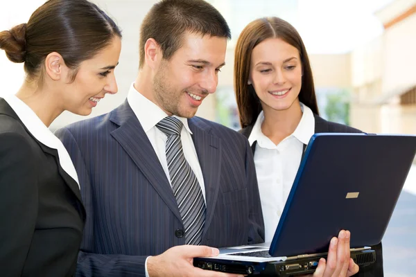 Jóvenes empresarios con portátil — Foto de Stock