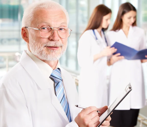 Doctor with two attractive nurses — Stock Photo, Image