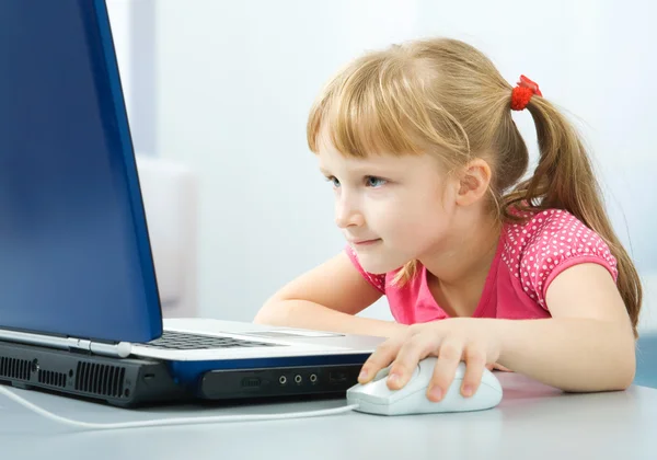 Schoolgirl with laptop Royalty Free Stock Images