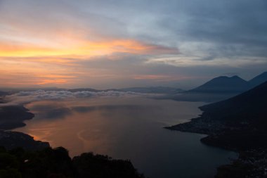 scenic view on mountains lake water and sky with sunset in clouds, aerial view