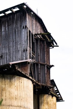 old wooden hut, broke barn on huge water containers