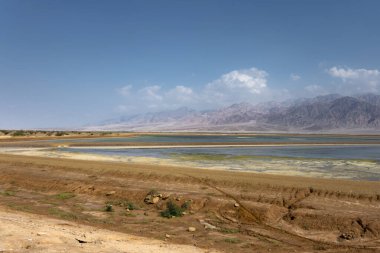 cloudy sky, desert hills and Eilat Aqaba gulf at Red sea, southern Israeli port 