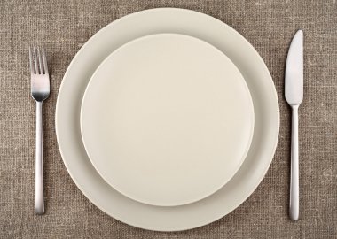 Tablo ayarı. bej tabak, çatal, bıçak ve bej keten masa örtüsü