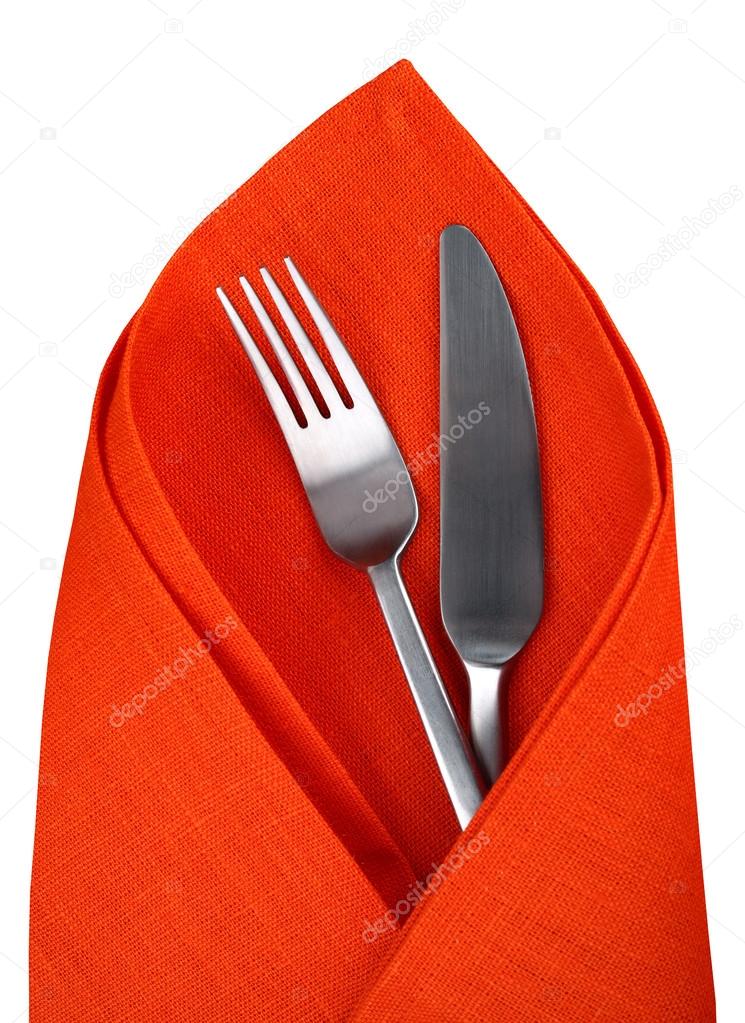 Orange napkin with knife and fork isolated.