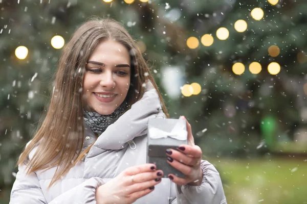 Merry Blond Woman Holding Gift Box Snowfall Empty Space — Stock Photo, Image