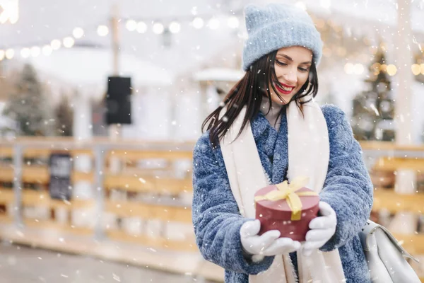 Happy Brunette Woman Wears Knitted Cap Blue Coat Holding Red — Stock Photo, Image