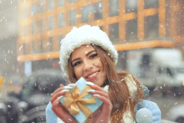 Attractive Blond Woman Wears White Knitted Cap Holding Blue Gift — Stock Photo, Image