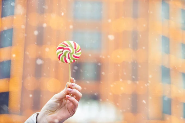 Woman Holding Caramel Candy Snowfall Space Text — Stock Photo, Image