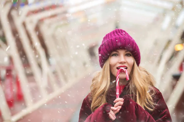 Charming Blond Woman Wears Knitted Hat Eating Sweet Candy Cane — Stock Photo, Image