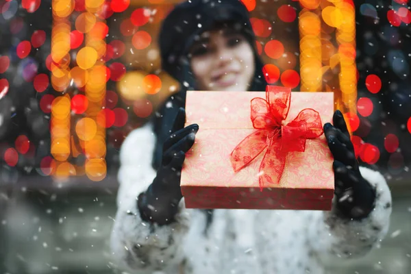Pretty Young Woman Receiving Gift Holiday Fair Snowfall Empty Space — Stock Photo, Image