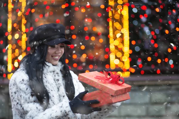 Surprised Young Woman Receiving Gift Holiday Fair Snowfall Empty Space — Stock Photo, Image