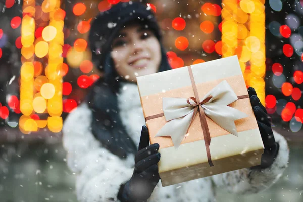 Merry Young Woman Receiving Gift Holiday Fair Snowfall Empty Space — Stock Photo, Image